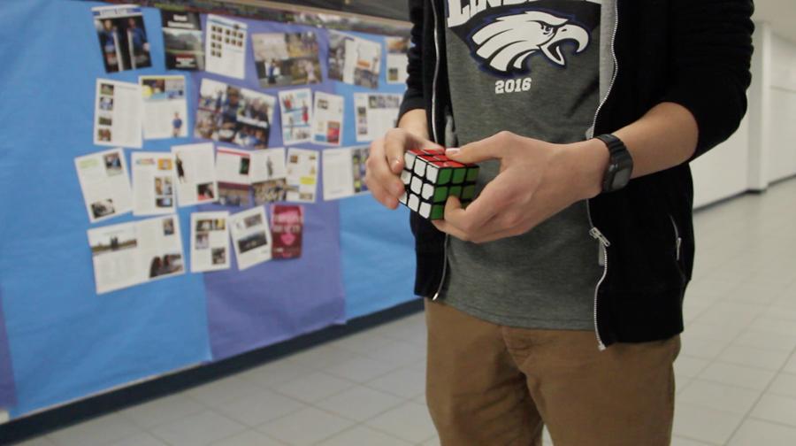 Student Jordan Palmer solves his speed cube