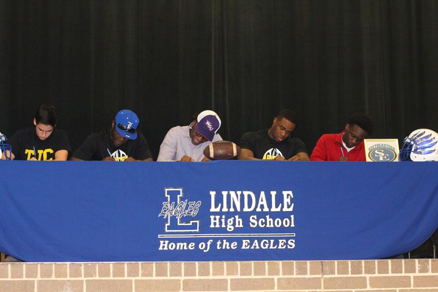 Eagles players sign to play college football.
