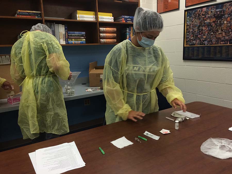 Students work with pharmacy items to prepare for the upcoming certification test.