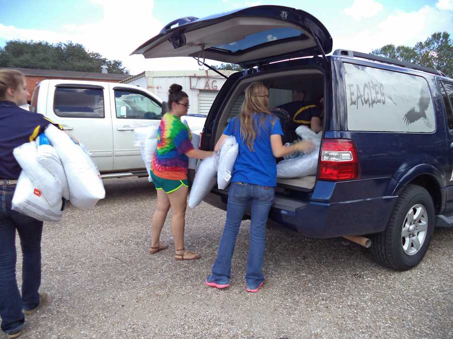 FFA students load donated items into car for delivery.The service was one of many that the FFA has planned for the year.