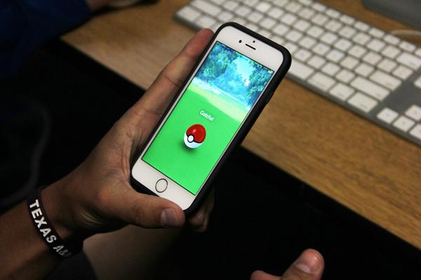 Student celebrates as he catches a Pokemon.