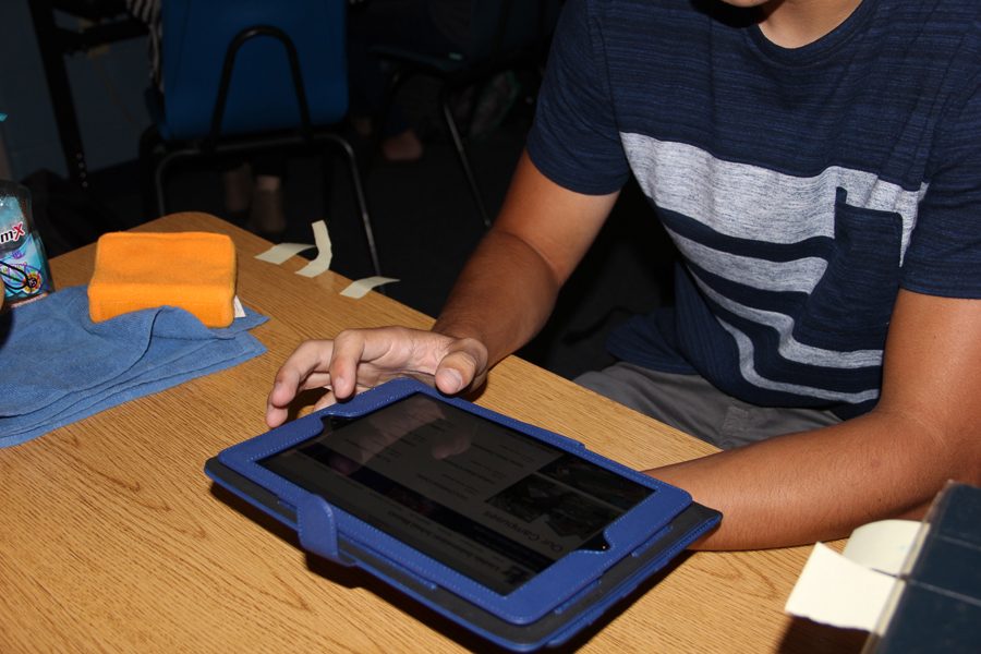 A student researches on an iPad for a homework assignment.