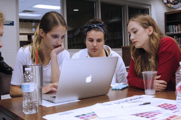 Staff members work on design ideas at yearbook workshop