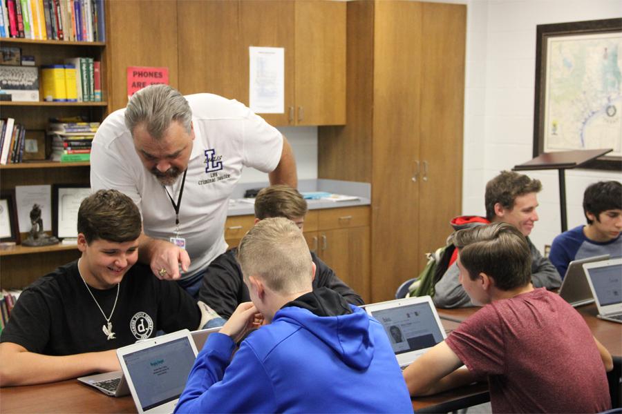 Johnson instructs students working on a project. He also helped lead the first meeting of the Law Enforcement Explorers Unit.