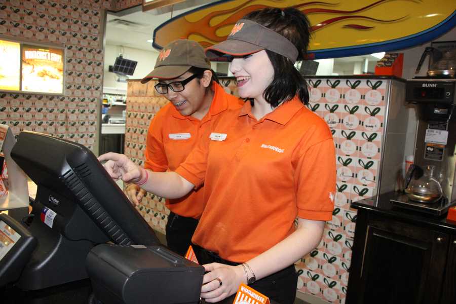 Juniors Juliee Acosta and Isabella Weitzel working at Whataburger