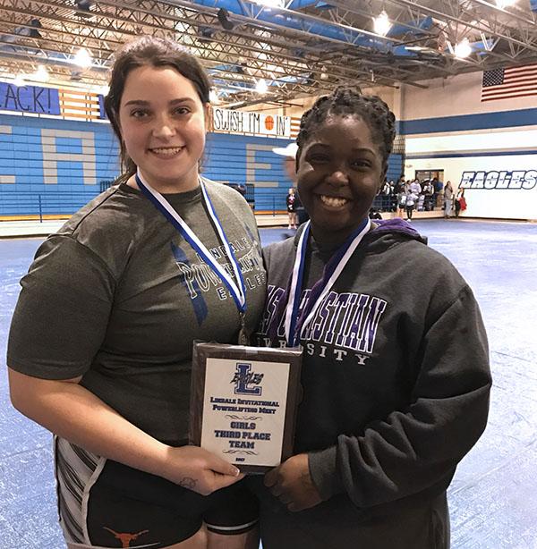 Grace+Reynolds+and+Amina+Petty+celebrate+winning+first+place+in+their+weight+classes.+The+girls+powerlifting+team+won+third+overall.