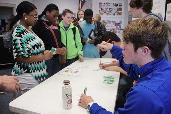 Senior David Franke calculates the profits from his concession stand.