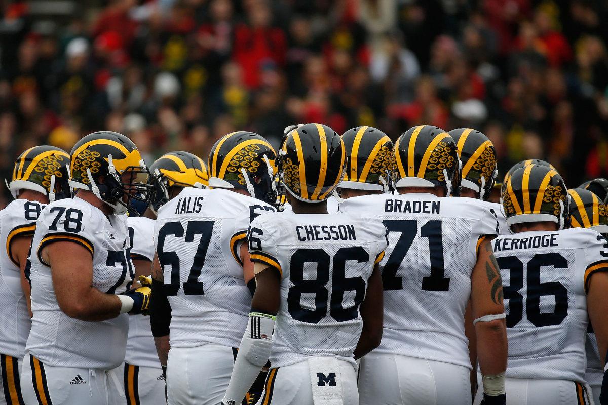 The University of Michigans 2015 Wolverines in a pre-game huddle. The team is one of few that generate over one hundred thousand fans per game, on average.