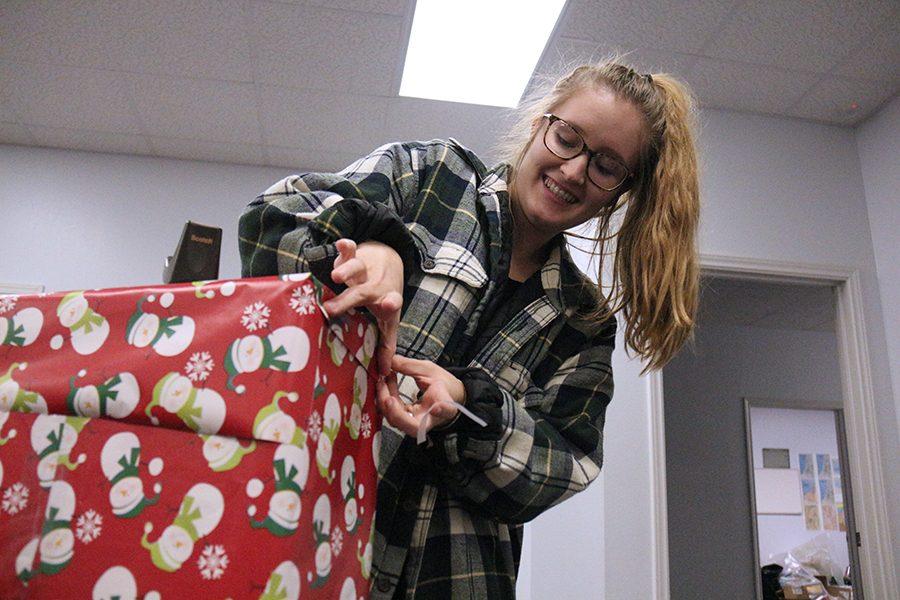 Calli wraps a present for the Key Club Christmas party.