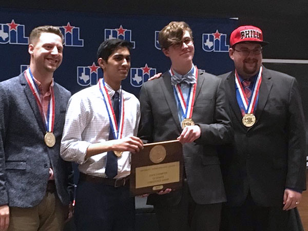 Junior Ronak Desai and Senior Jonas Thrasher-Evers celebrate their UIL State championship with coaches JP Fugler and Rory McKenzie. The teachers have coached individuals and teams to state championships already this year.