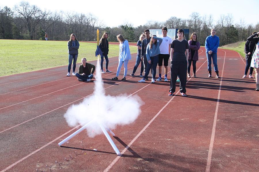 Students watch as the rocket successfully shoots into the air. 