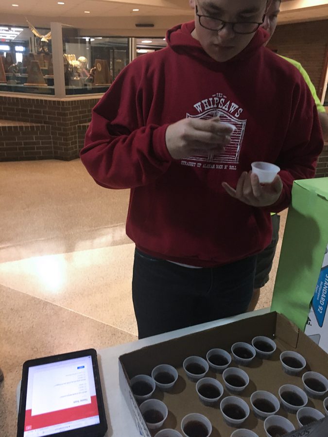 Junior Patrick McClain taste tests a product. Dozens of students participated in the experiment.