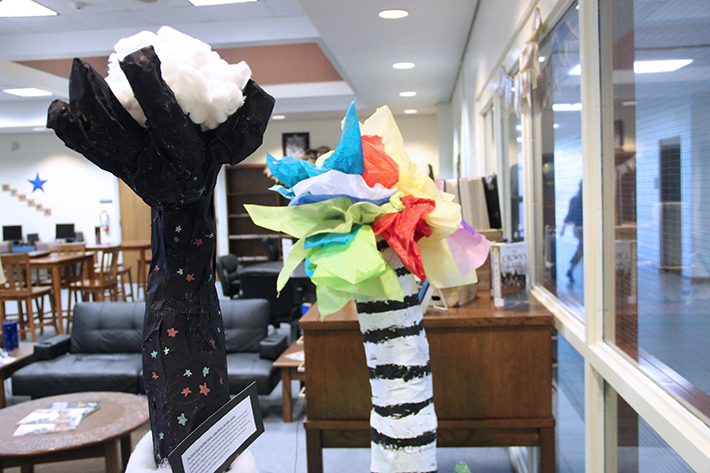 Students art projects on display in the school library. The independent sculptures feature short descriptions of each piece.