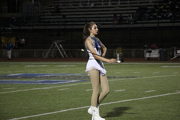 Whitney Bacon marches during the halftime show of a football game.