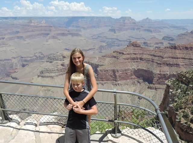 Kaitlyn Barrington holds her brother, Austyn Barrington, as they look out over the Grand Canyon. Her little brother was scared of the height, so she comforted him. 