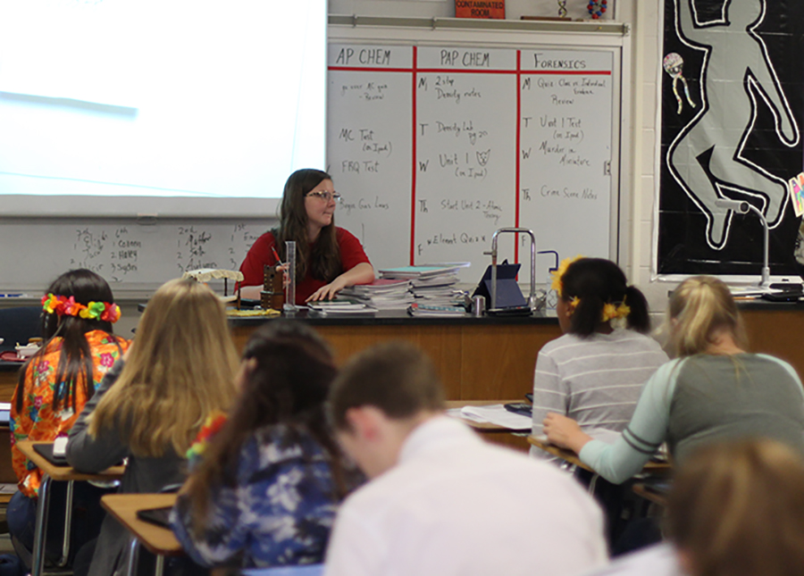 Mara Griffin grades papers while students take a test.  She began student teaching sophomores in Pre-AP Chemistry class.