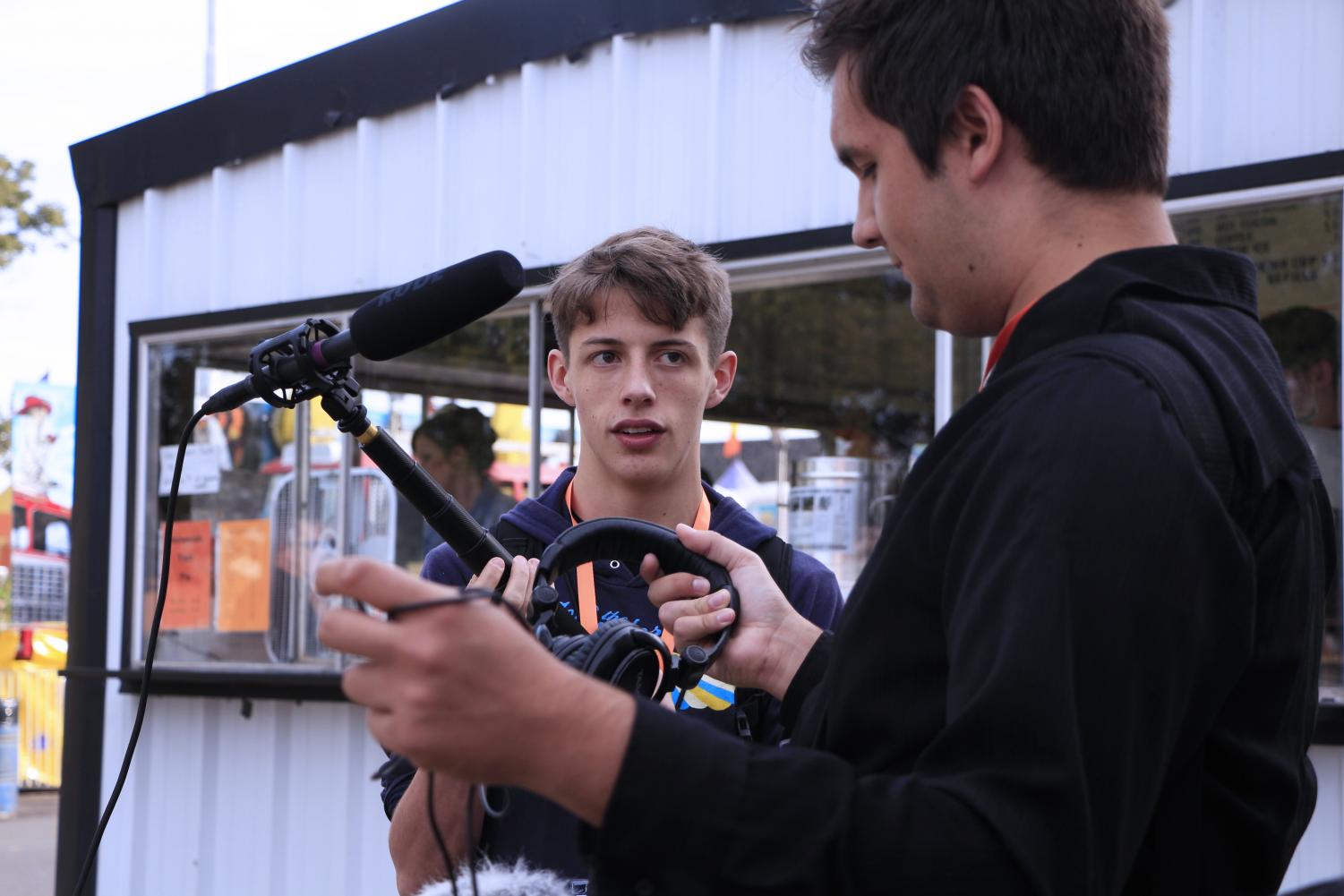 Sophomore Gabriel Ledesma and Senior Zac Brooks filming at the East Texas Yamboree. Ledesma and Brooks worked as the sound operators for the crew.