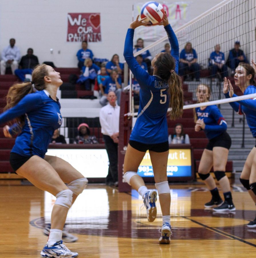 Sophomore Harleigh Thurman sets the ball to junior Brina Kuslak in their first round playoff game against Temple. The Lady Eagle won the game in four sets, winning 25-13, 25-17, 16-25, and 25-19.