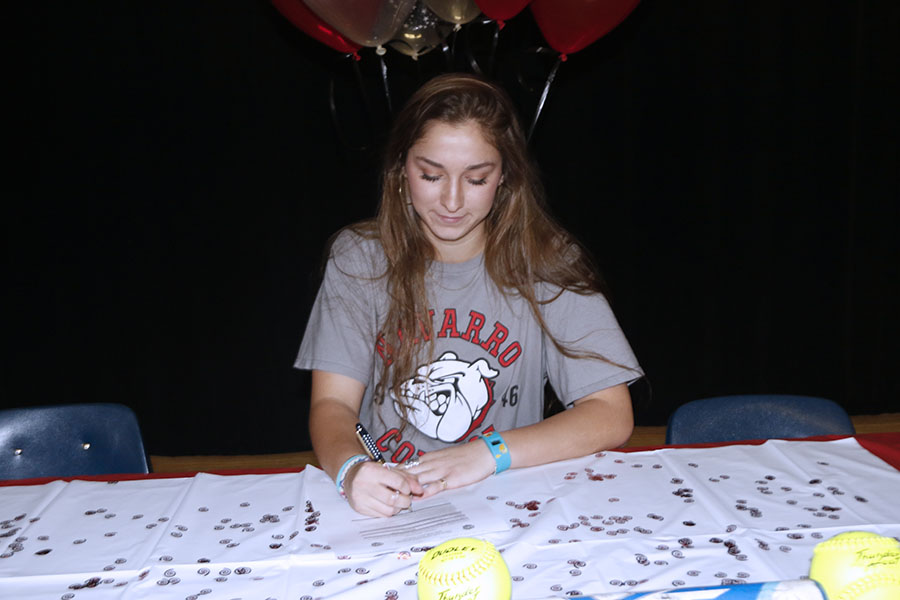 Senior Lorin Reue signs for a softball scholarship. Reue will be attending Navarro College.