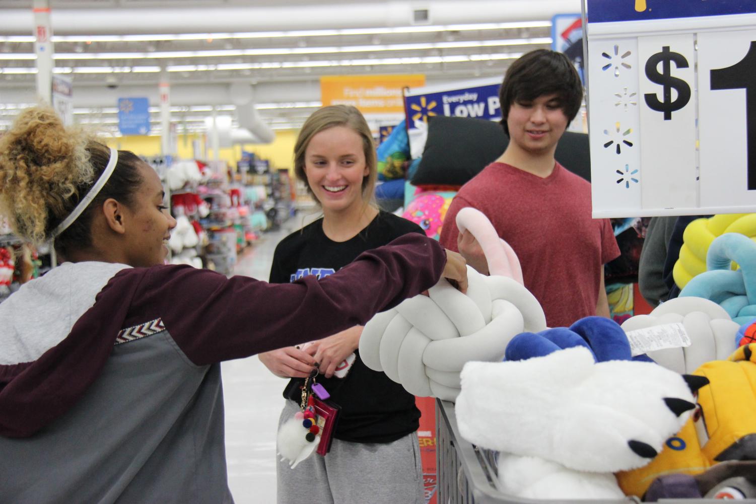 (From left to right) Senior Lauren Sumner, junior Braeleigh Flickenger and senior Logan Maynard shop for the angel gifts. NHS members went to Walmart and Target on November 30th.
