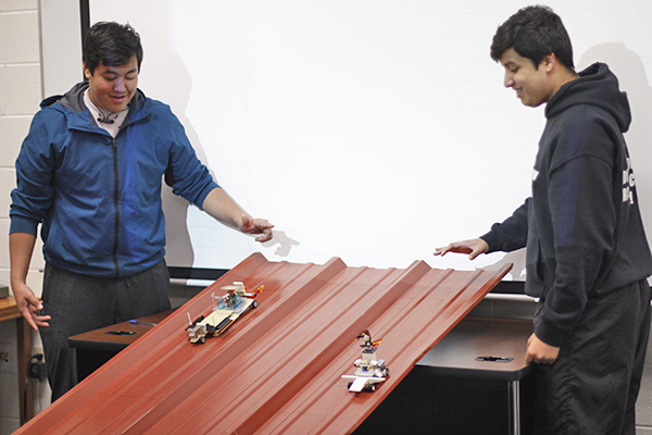 Junior Nathanyel Odama and sophomore Stephen Walker race their cars down the metal track. Each students built a car of their own design.