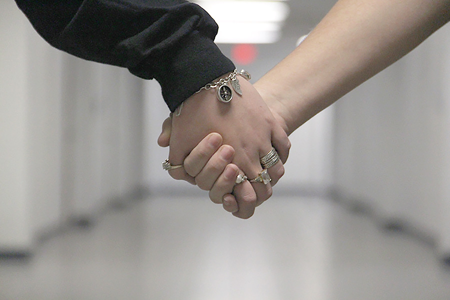 Students hold hands as a friendly gesture. Results from a Valentines Day-related quiz revealed opinions about the holiday from the student body.