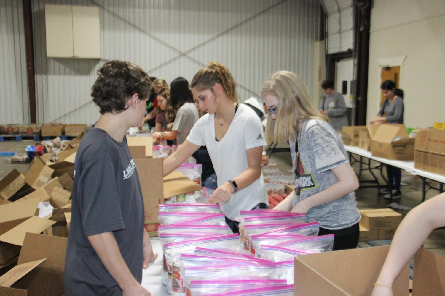NHS student volunteers pack food bags at East Texas Food Bank. This organization has acted as a saving grace for many hungry families.