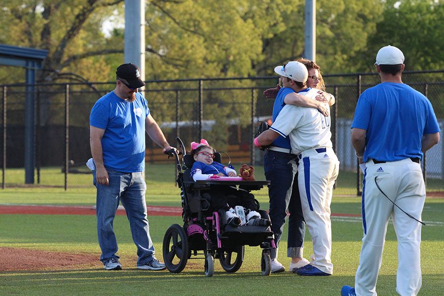 Senior+Conner+Heller+and+his+mom+embrace+as+Lucy+prepares+for+the+first+pitch.+Her+father+threw+the+first+pitch+of+the+game+for+her.
