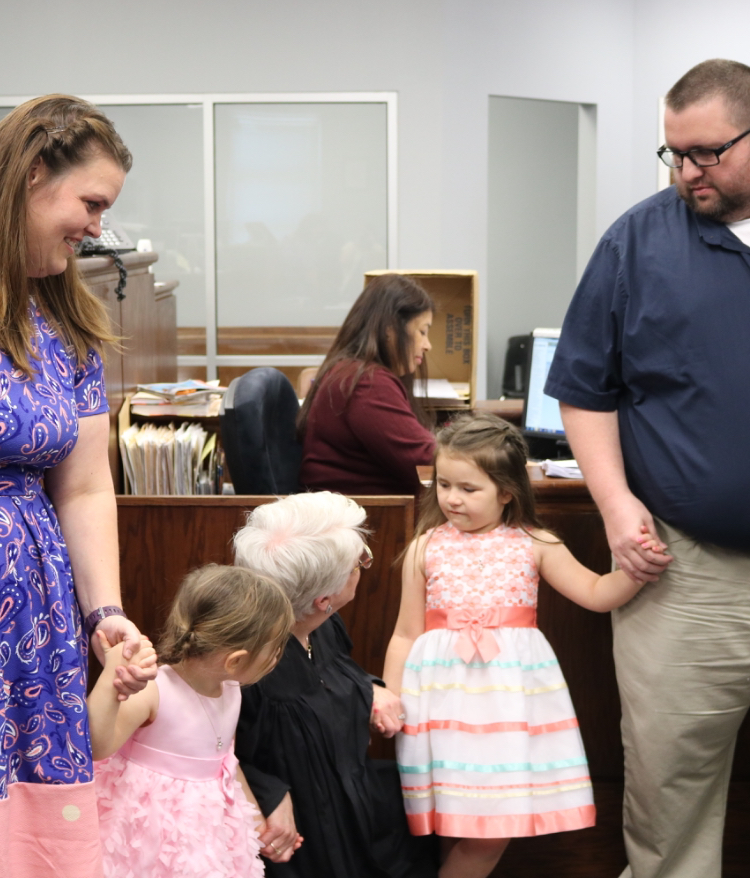 Judge Clark officially announces that the girls are adopted. Art teacher Rebecca Harrison and her husband have been fostering their daughters for 16 months.