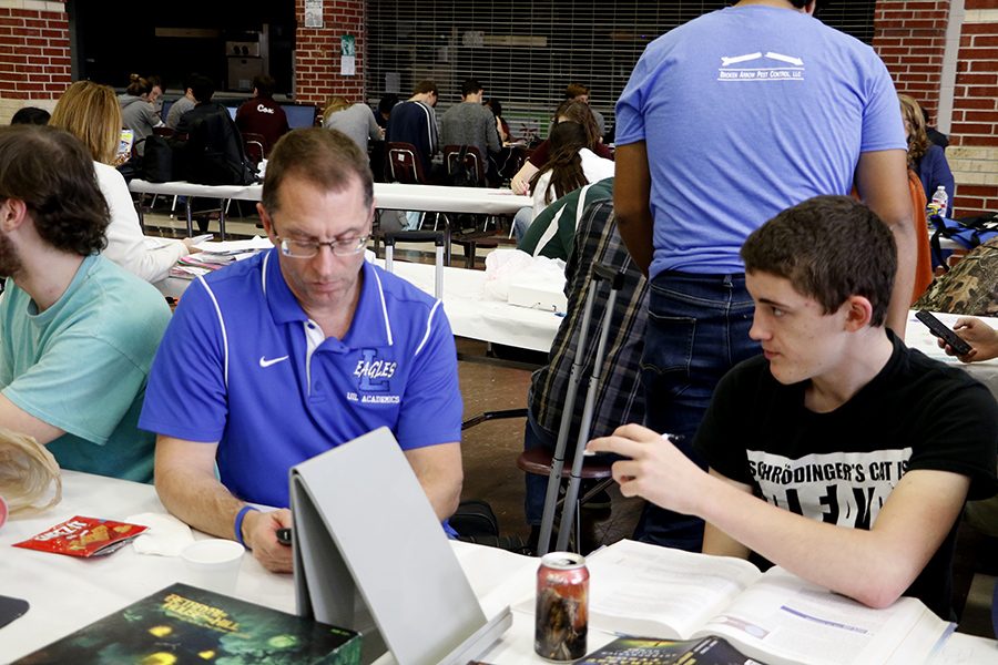 Physics teacher Duane Walton assists his science UIL team. They practiced in their free time in between competitions.