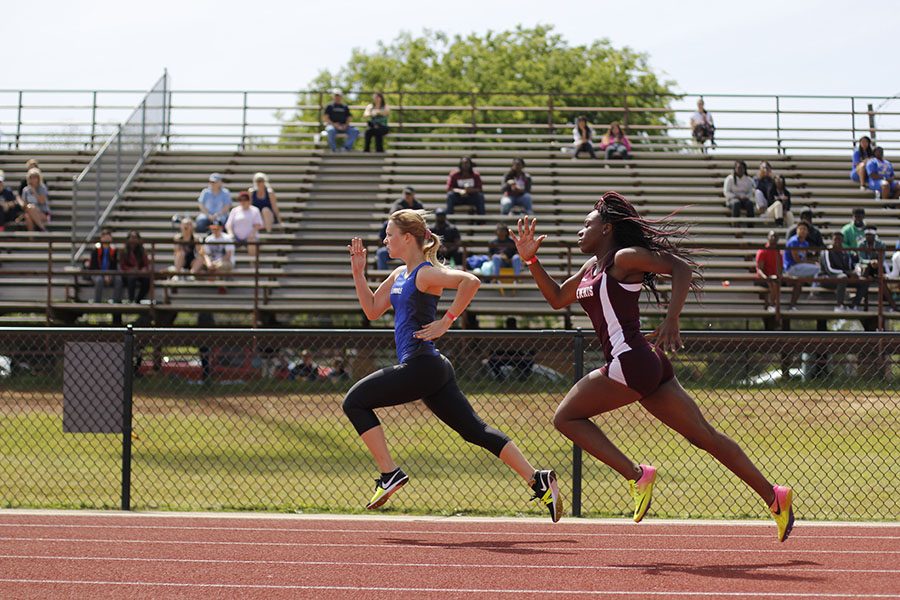 Junior Moriah Franke runs the 200 at the district meet. The varsity girls placed third overall. 
