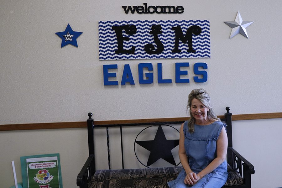 Fourth and fifth grade reading intervention teacher Gretchen Nees poses near a sign at E.J. Moss Intermediate. Nees is the teacher of the month.