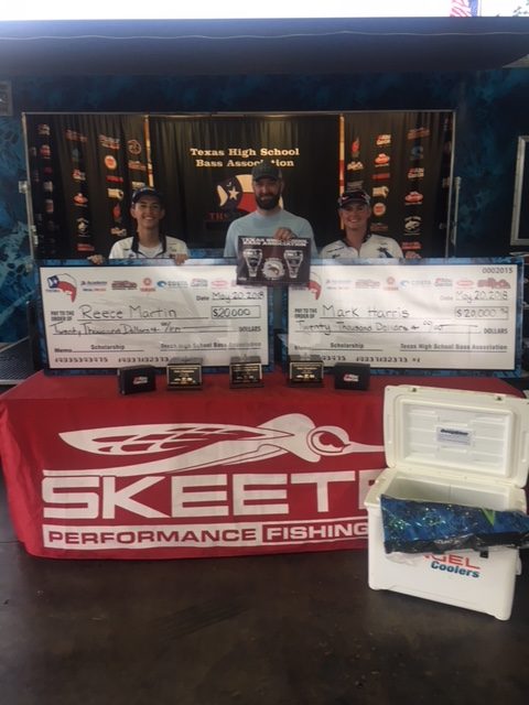 Martin (left) and Harris (right) hold their scholarships for $20,000 each that they won in the bass competition.  The team reeled in 40.22lbs of fish over the two days of competition.