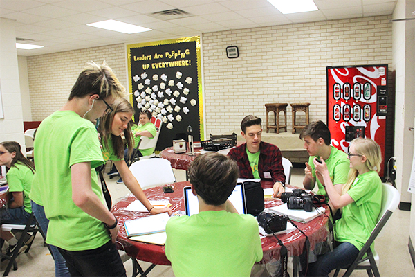 Upcoming newspaper staff works on writing styles. They attended many lessons throughout the day.