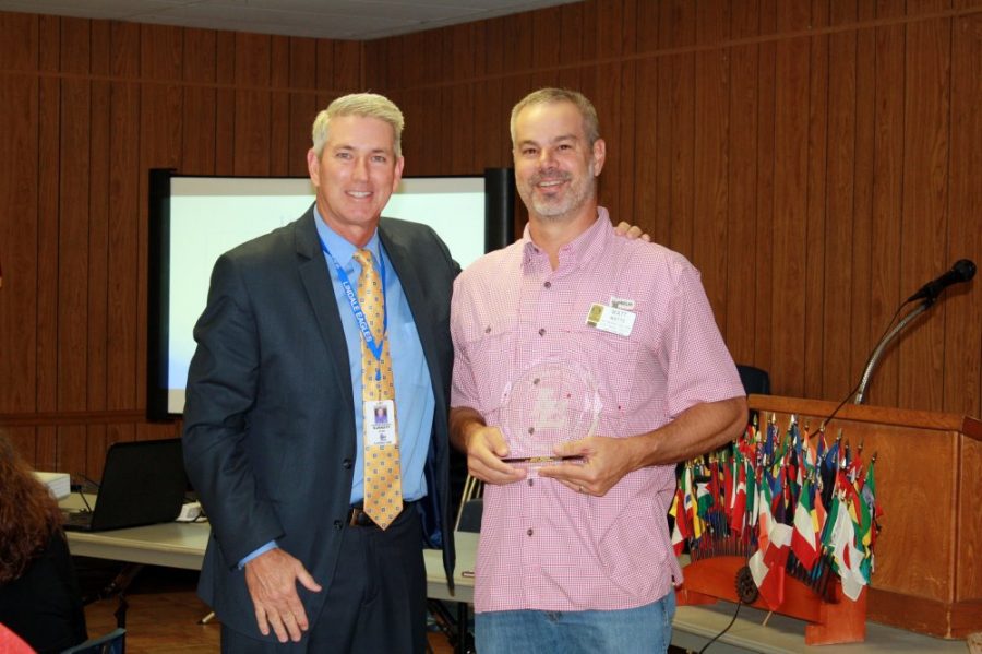 Surratt Presents Former Board President With a Rotary Award