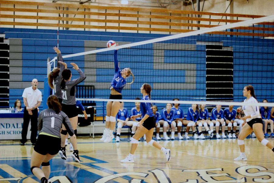 Senior Brina Kuslak spikes the ball in a game against All Saints. The team won in straight sets with scores of 25-15 in each set.
