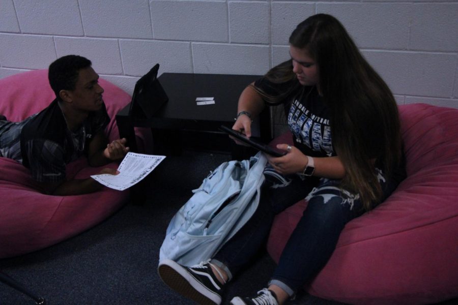 Juniors Christian Wood and Bree McHam relax on beanbags while working on a project in English teacher Kristin Quarles class. This is the second year Quarles has had this seating in her class, and many of her students regularly take advantage of the seating arrangements.
