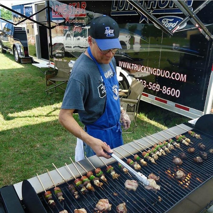 The late Jesse Rodriquez grilling before a tailgate event. Rodriquez enjoyed cooking and serving his community. 