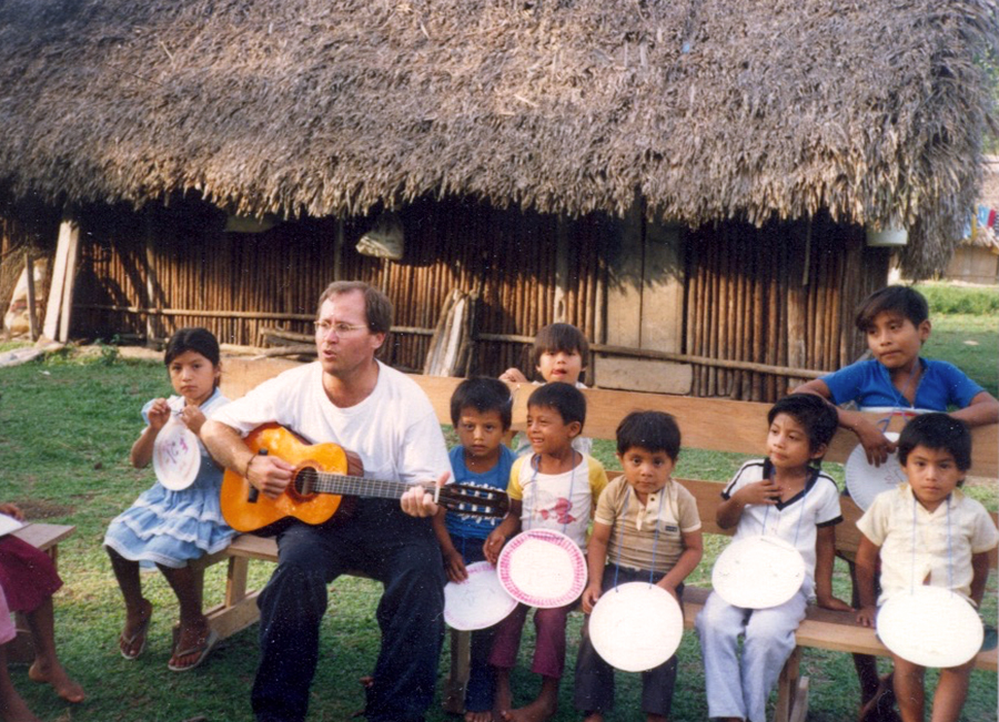 Mike Maddox plays and sings for children. He led group activities for the children in Belize. 