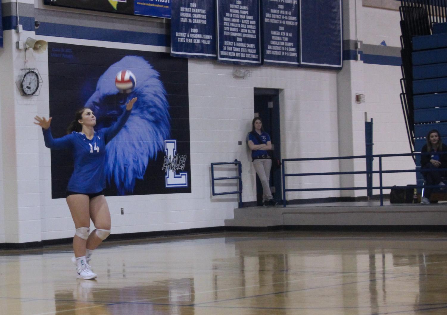 Senior Hannah Knox tosses the ball up to serve it against Carthage. The team played a double header with Carthage and Quitman and won both games in straight sets.