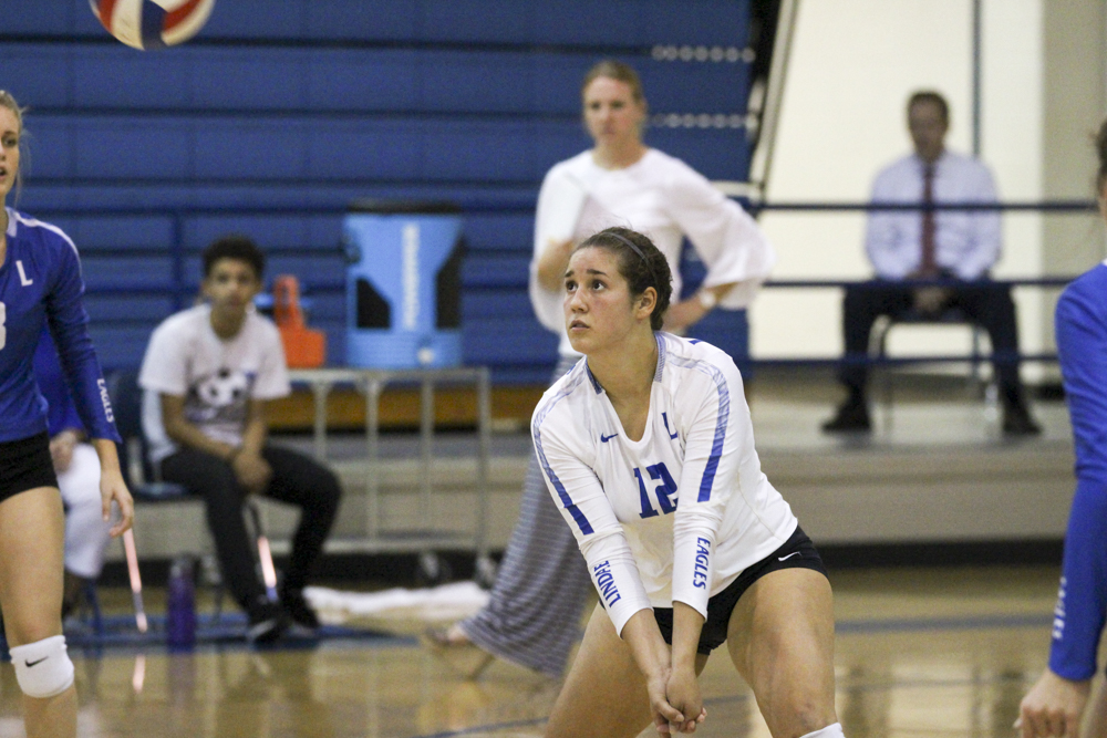 Senior libero Jennifer Moyer watches the ball and gets ready to pass it to her awaiting teammates. The varsity team played in Longview at a tournament, where they smoked their competition.