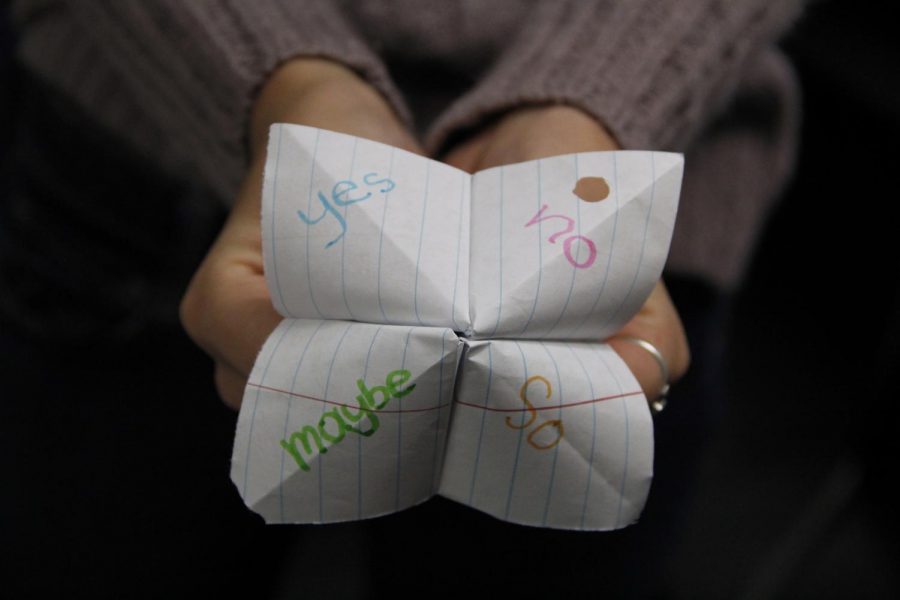 A student holds up a fortune teller with choices written. This is a representation of what I have to go through.