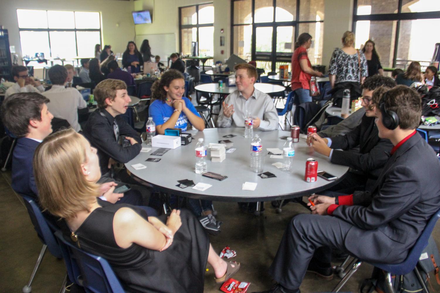 Speech and debate students enjoy a game of cards between rounds at the All Saints tournament. The team won third place sweepstakes at that tournament.