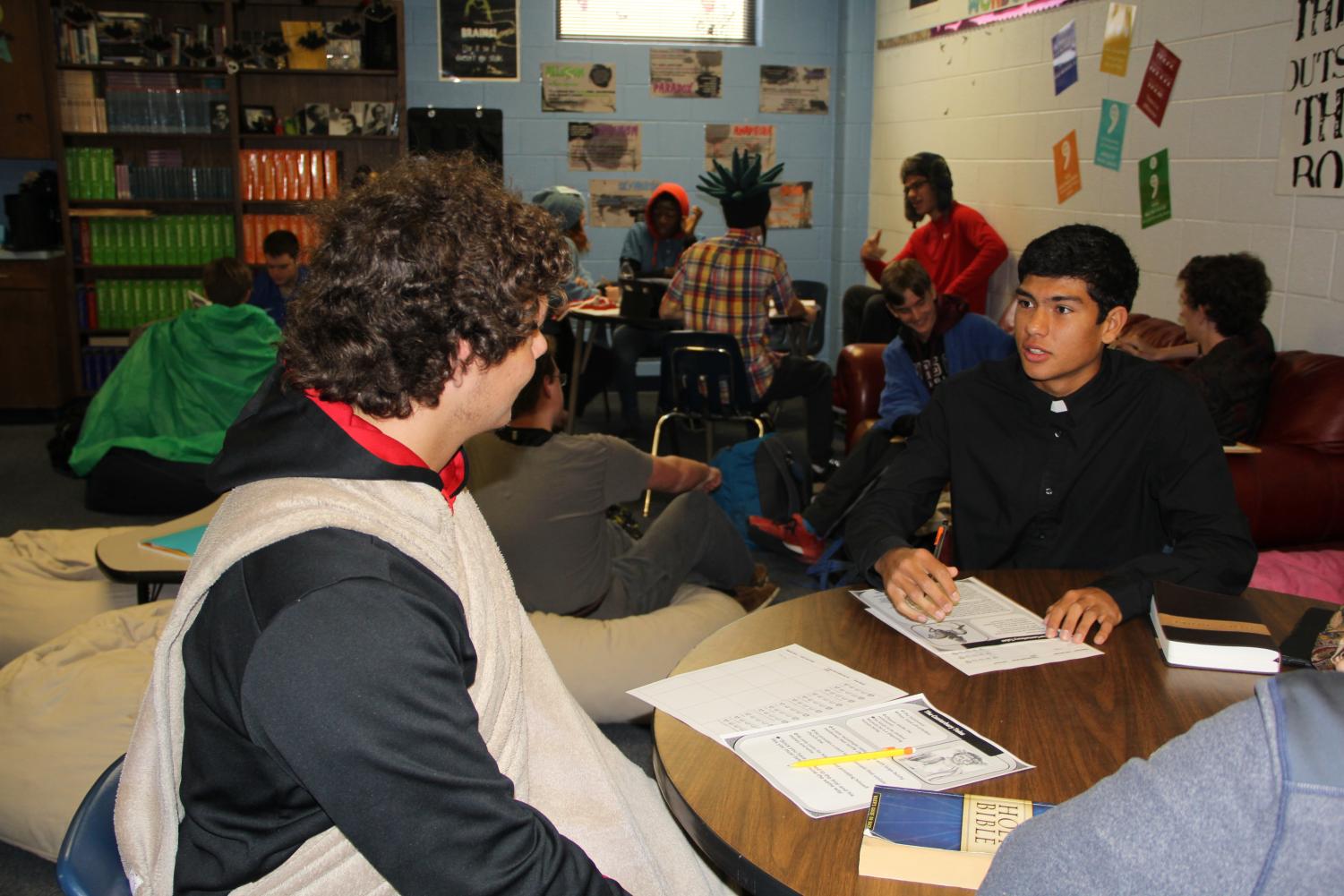 Two students engage in book dating. Rick Samaraweera (right) is giving a brief presentation of his book to another student.