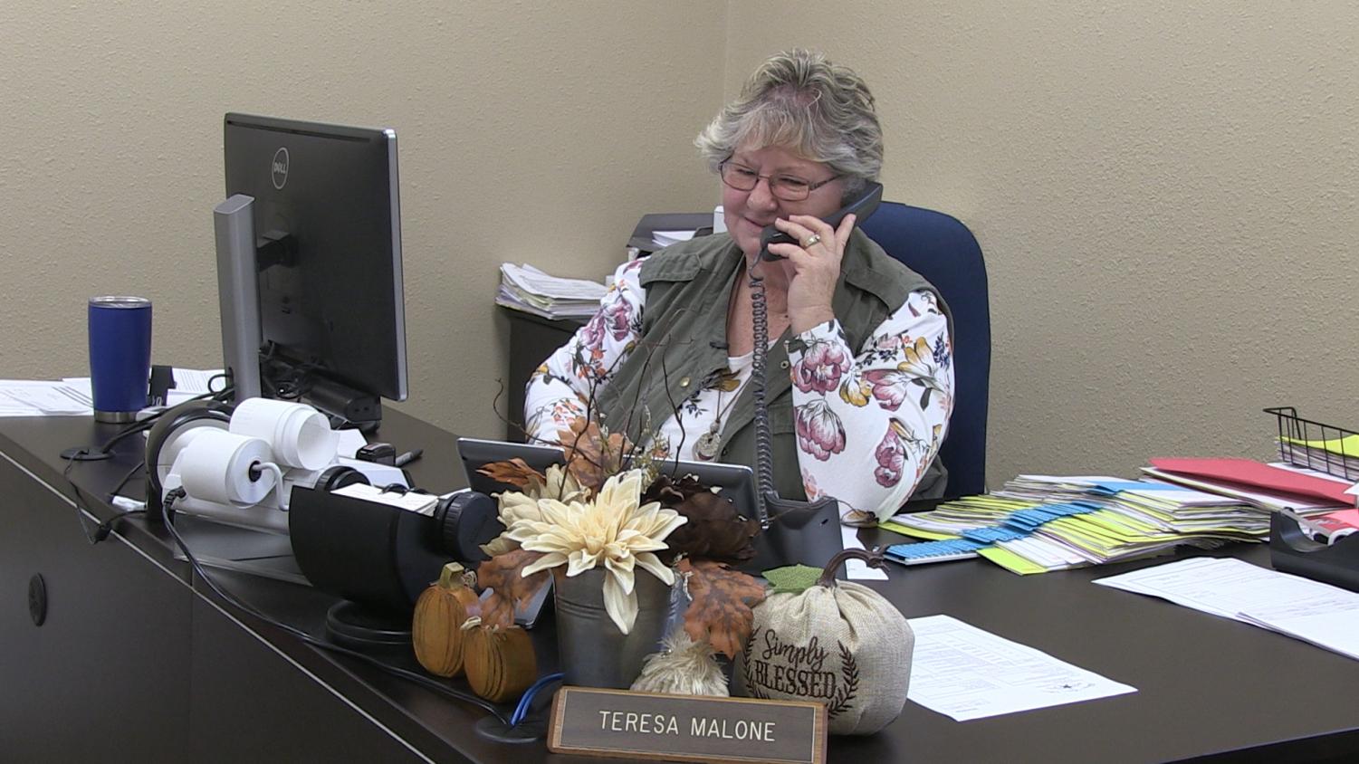 Teresa Malone answers telephone calls regarding financial situations. She is in charge of paying the bills for LISD.