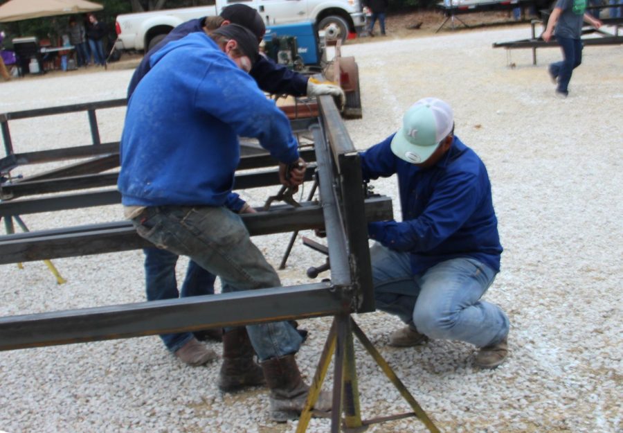 Three Lindale students work on their trailer at the trailer build on December 6. Several Lindale teams competed in either the trailer build off or the cooking competition, along with teams from different schools around the area. 