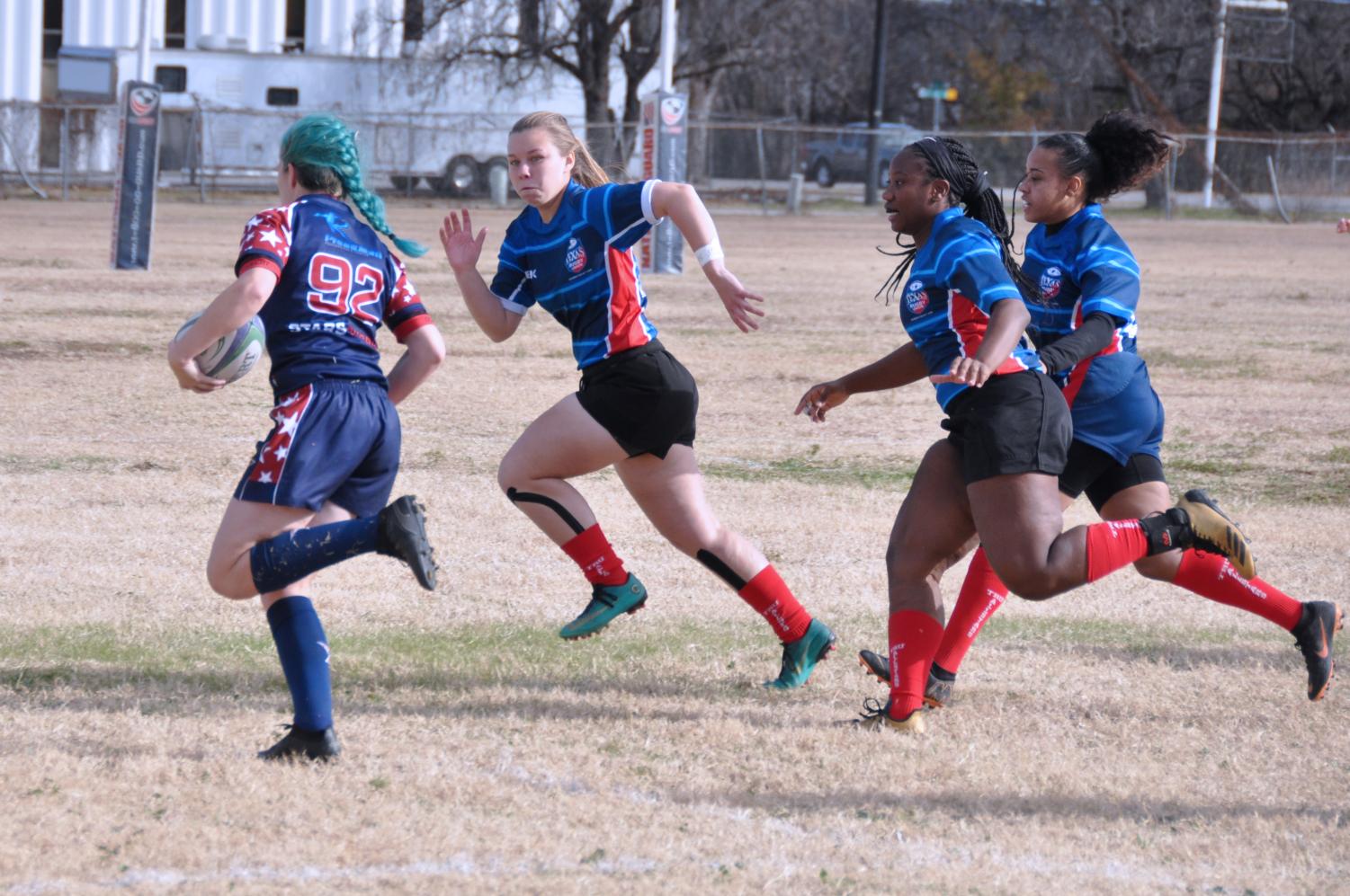 Lindale alumna Lynsey McKinney heads upfield with her All-Star teammates. She also recently attended a rugby camp in California.