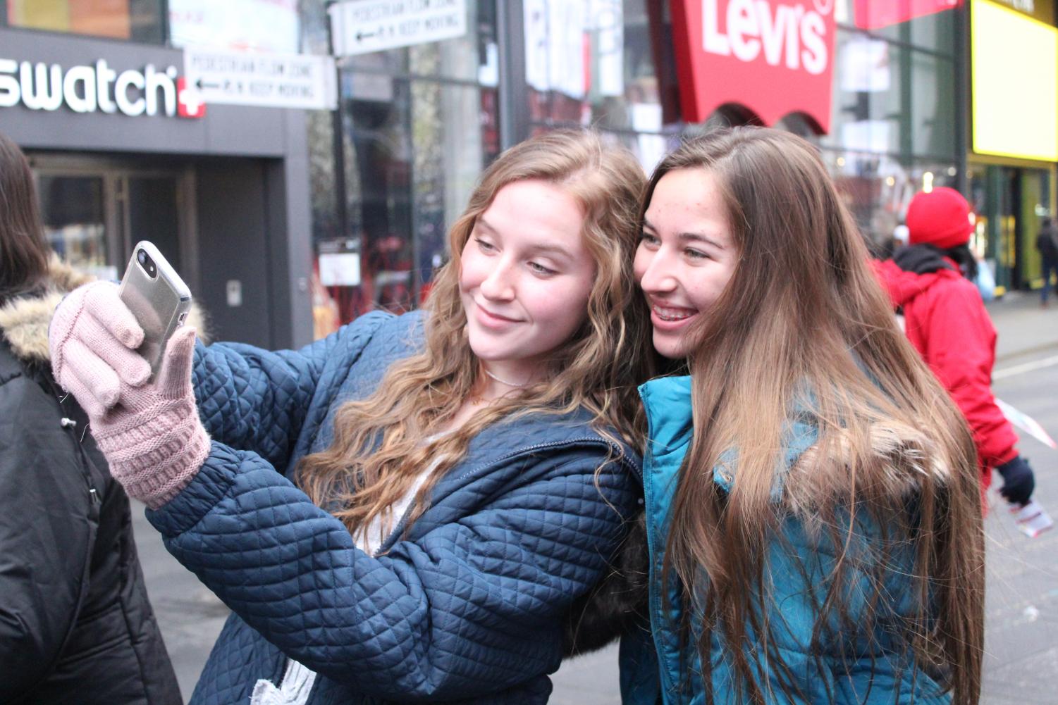 Kaitlyn Gibson and Sydni Segroves pose together for a selfie in Time Square.