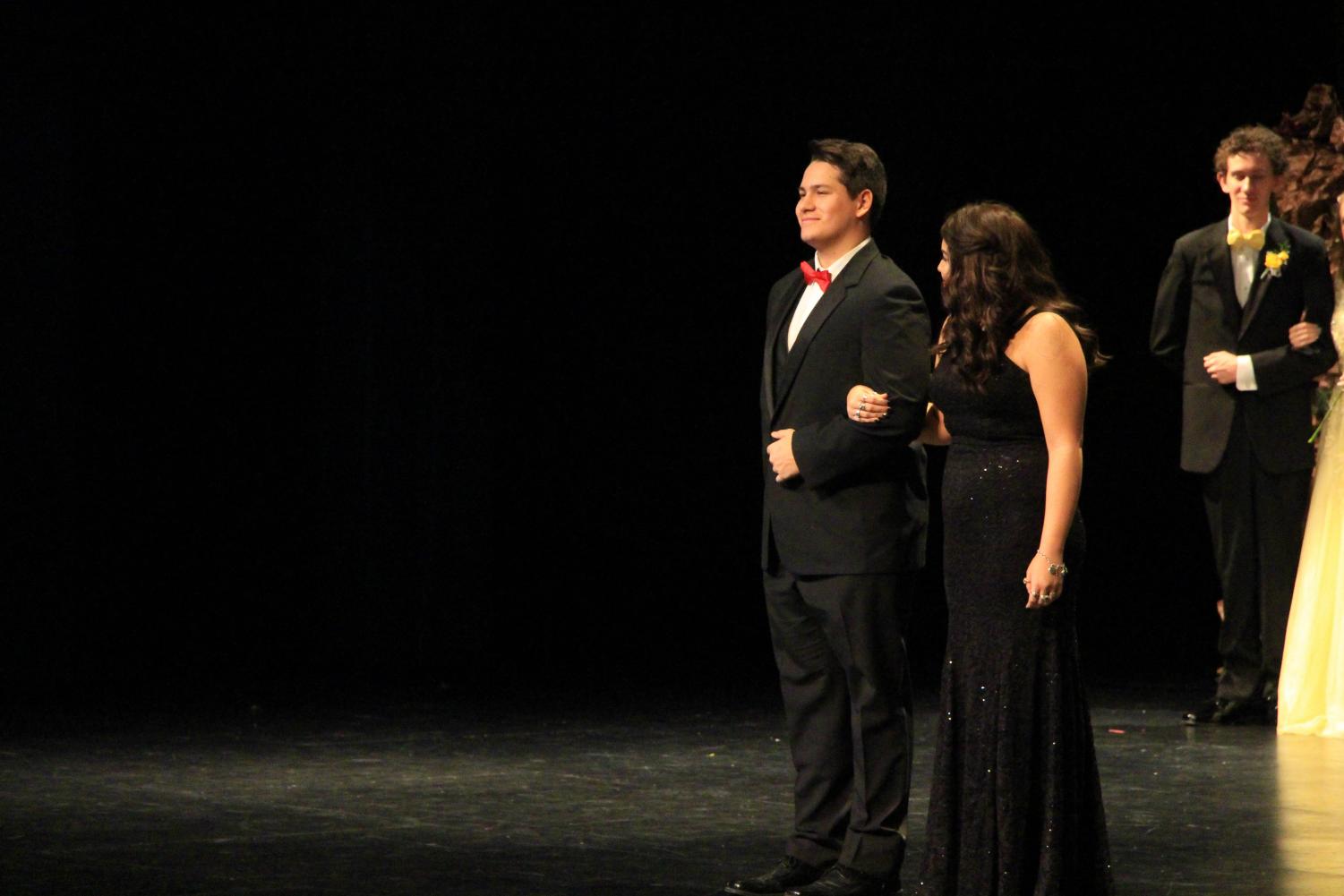 Senior Jonah Flores escorts senior Haylee Haxton across the stage. Haxton was nominated as a candidate for queen at coronation.