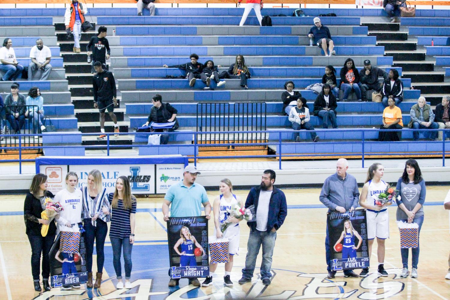 Seniors Sarah Kiser, Reagan Wright and Molly Purtle are presented at senior night. They were escorted by family members to be acknowledged for their dedication to the team.